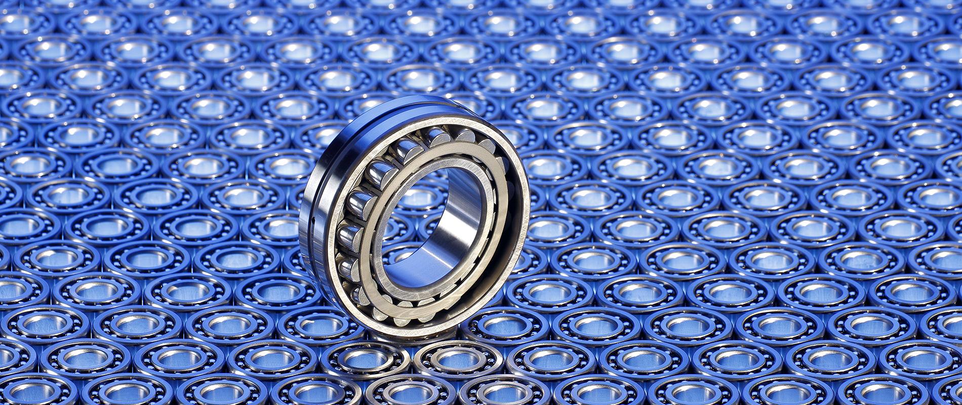 Ein Wälzlager in der Mitte eines Musters aus vielen identischen Lagern. Die Oberfläche ist glänzend und metallisch, mit einem blauen Hintergrund, der einen futuristischen Eindruck vermittelt.